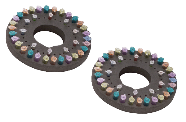 Two circular trays with colorful pastel crayon pieces on a white background